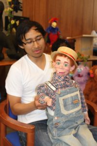 Teens learning ventriloquism at the Skirbal Museum